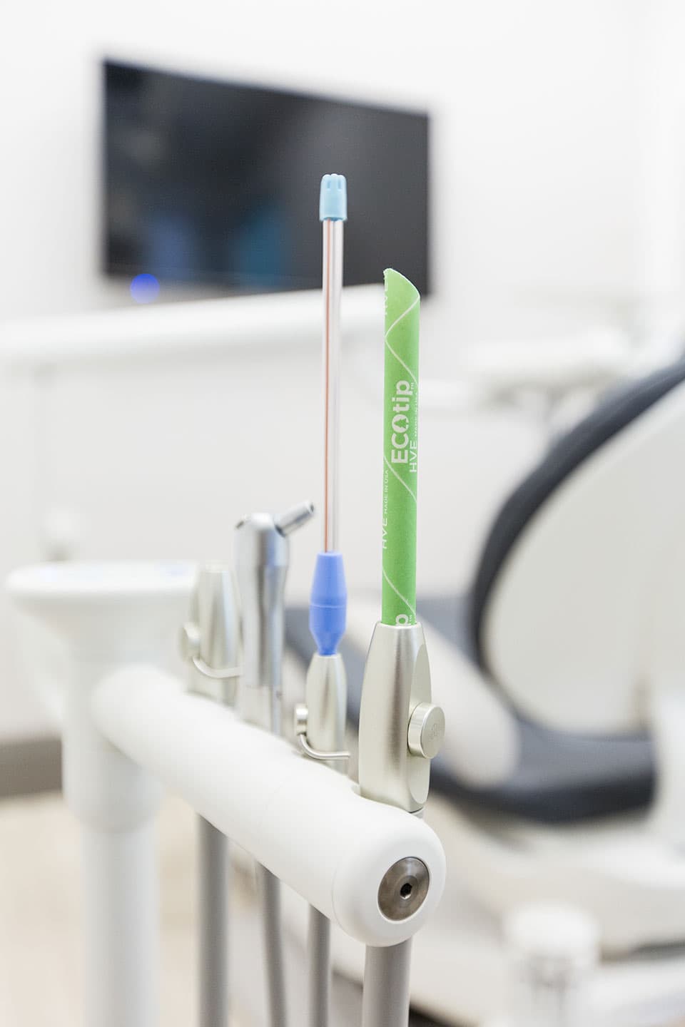 Biodegradable green Ecotip HVE suction tip mounted on dental chair instruments
